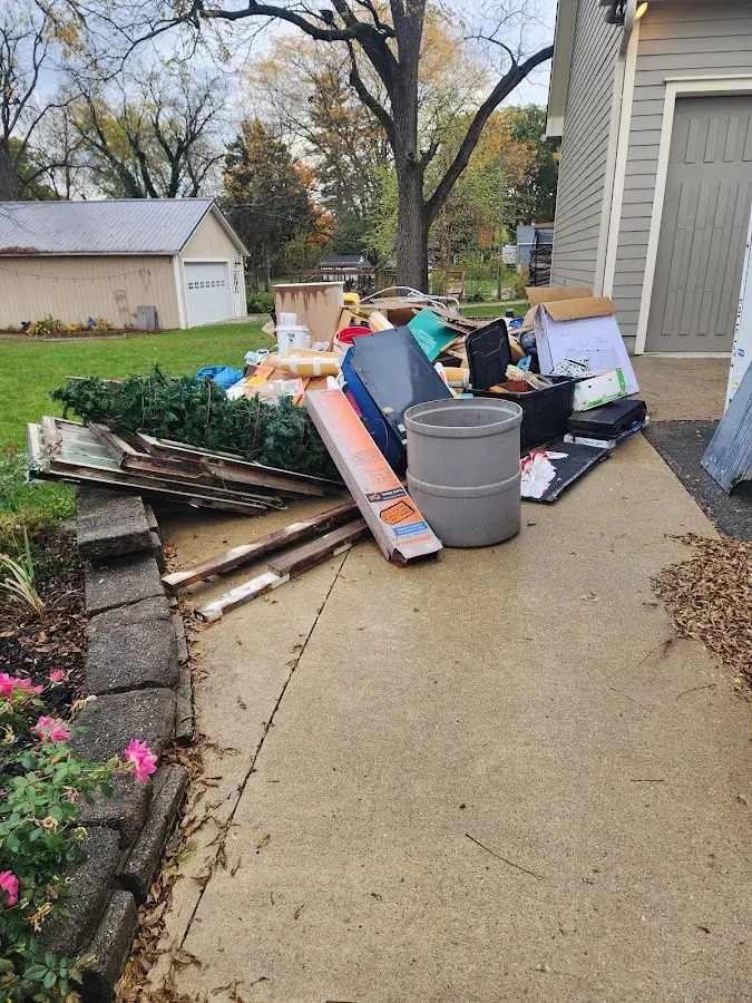 Dumpster being loaded with debris for Estate Cleanout Dumpster Rental in Locust Grove